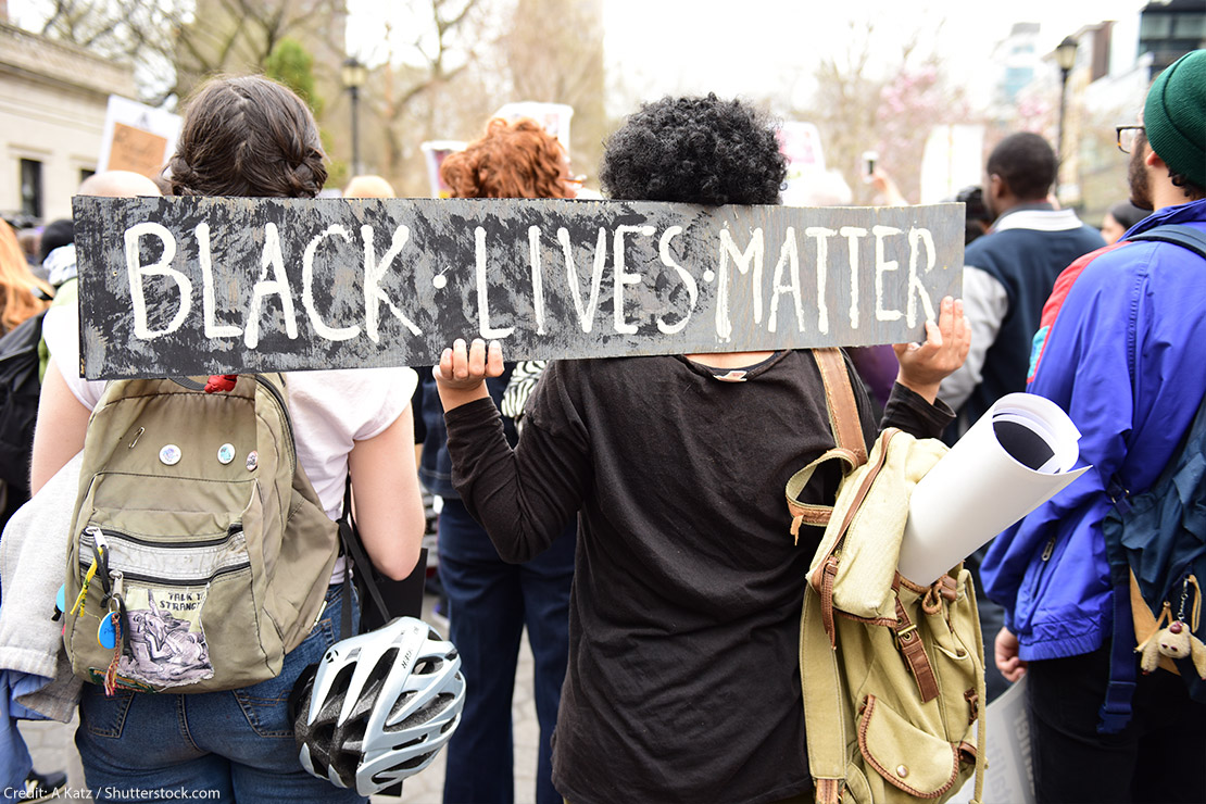 Protestors hold “Black Lives Matter” sign over their shoulders at a rally in Union Square before marching to Lower Manhattan.