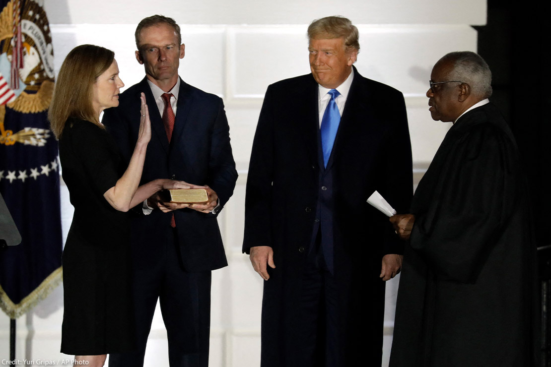 U.S. President Donald Trump smiles as Judge Amy Coney Barrett is sworn in as the Supreme Court associate justice by Justice Clarence Thomas on South Lawn of White House.