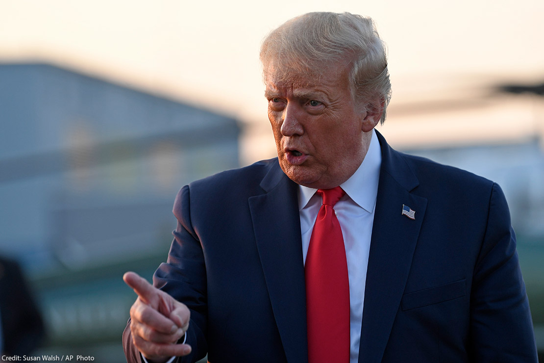 Trump wags finger as he talks to reporters before departing from a New Jersey airport.