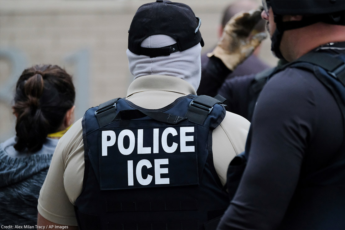 Back of an Immigrations and Customs Enforcement (ICE) officer's vest that reads "POLICE ICE." Taken in Portland, OR.