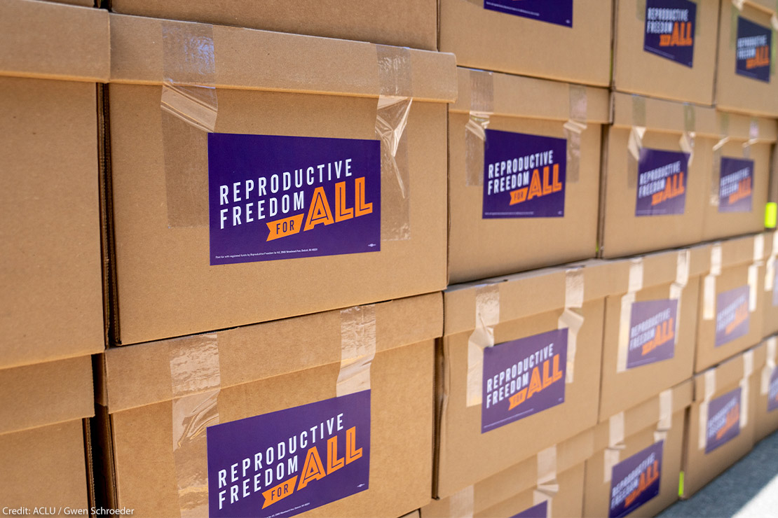 Stacked cardboard boxes that are marked "Reproductive Freedom For ALL" and contain signatures to put Proposal 3 on the ballot this November 2022, which would restore the protections of Roe v. Wade in the Michigan constitution.