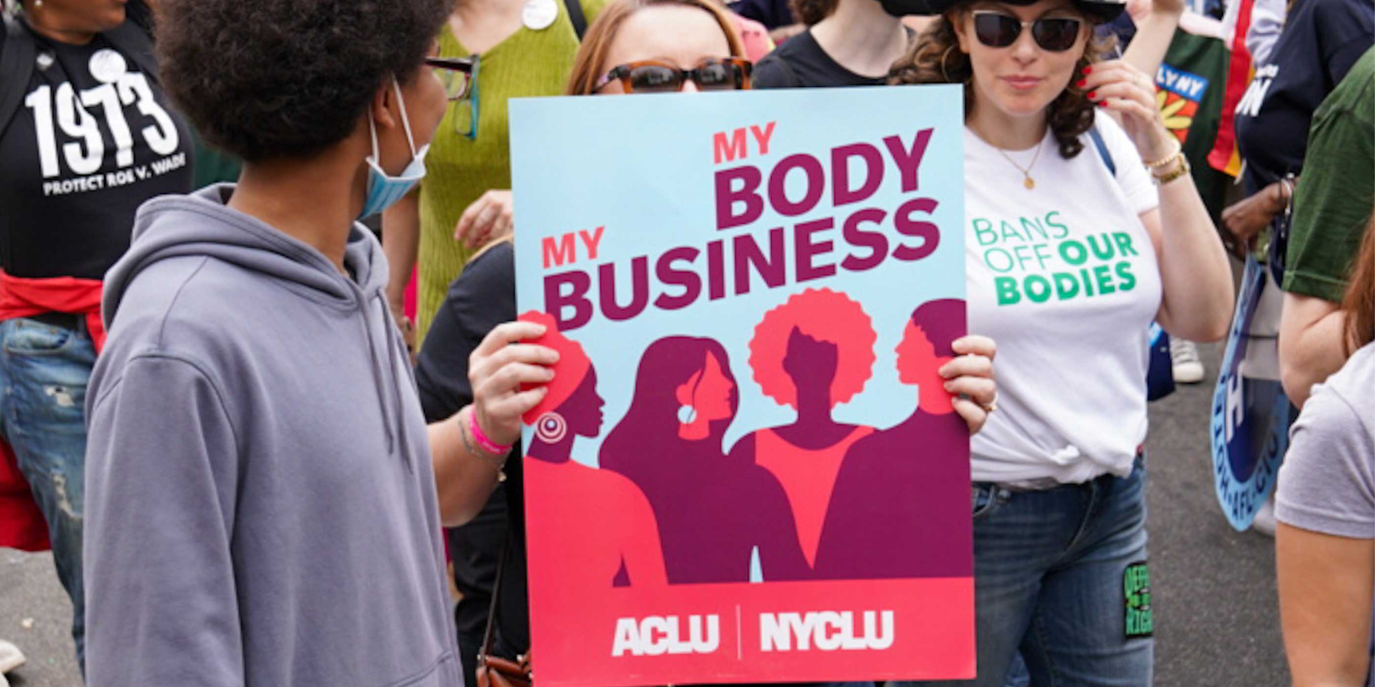 ACLU supporters marching at a reproductive rights rally.