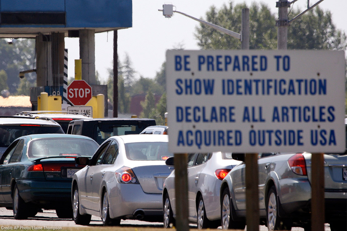 A line of cars wait to enter the United States from Canada in Blaine, Wash.