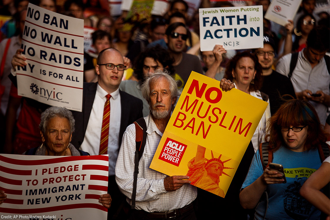 People protest during a rally about the U.S. Supreme Court's decision to uphold President Donald Trump’s ban on travel from several mostly Muslim countries.