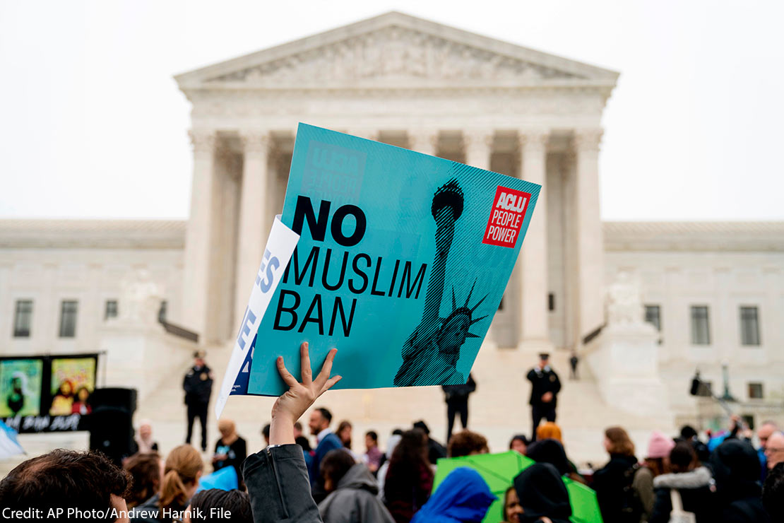 In this April 25, 2018 file photo, a person holds up a sign that reads "No Muslim Ban" during an anti-Muslim ban rally in front of the Supreme Court building in Washington, DC.