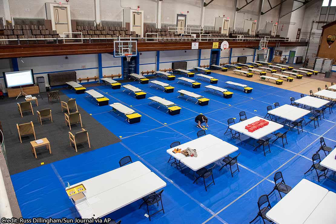 Community Concepts Wellness Shelter Attendant, marks the start of the meal line at the Lewiston Armory, in Lewiston, Maine on Wednesday, April 22, 2020.