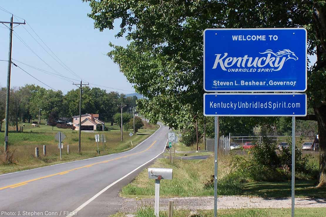 A Welcome to Kentucky road sign with the name of Governor Steven L. Beshear