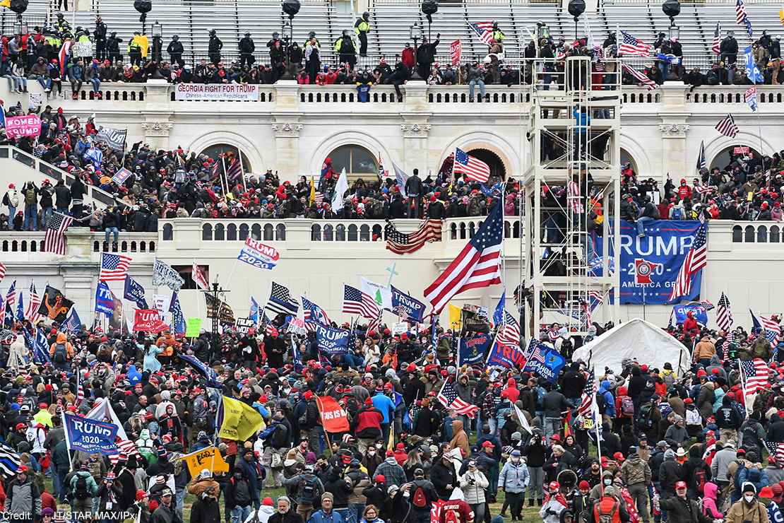 Insurrectionists amassing on the steps, walls, balconies, and grounds of the Capitol Building.