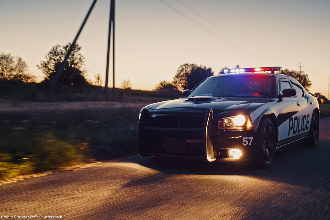 A police crd speeding down the road.