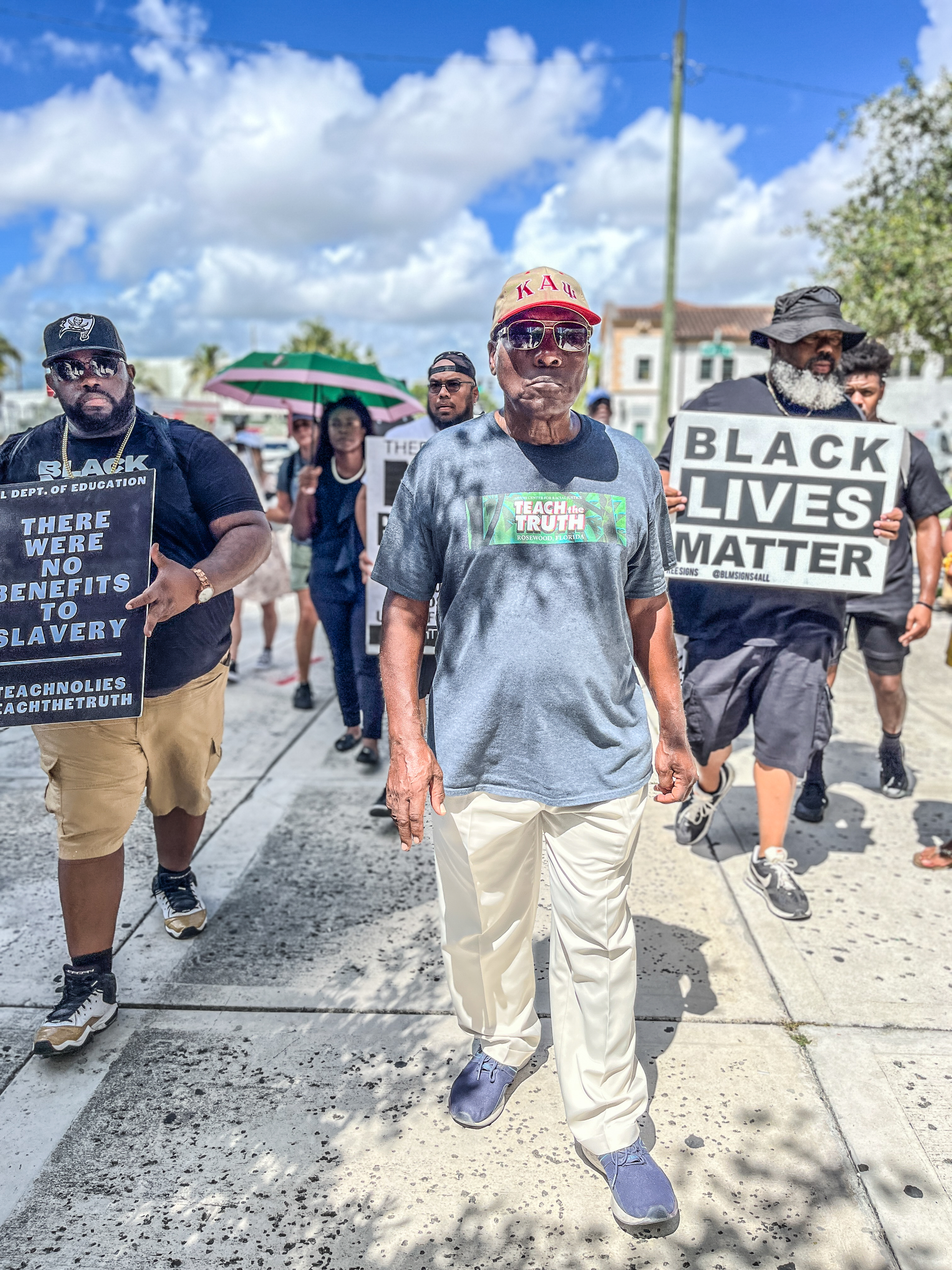 Dr. Marvin Dunn marches with folks in Miami in August 2023.