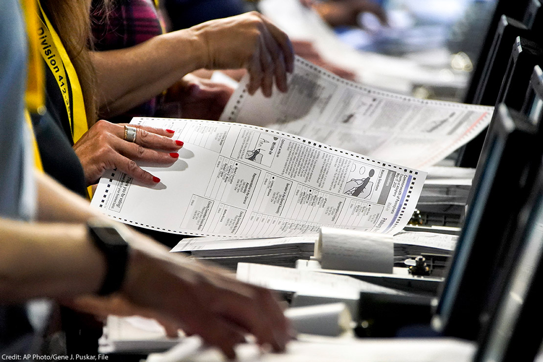 Election workers handle ballots at the Allegheny County Election Division warehouse in Pittsburgh.