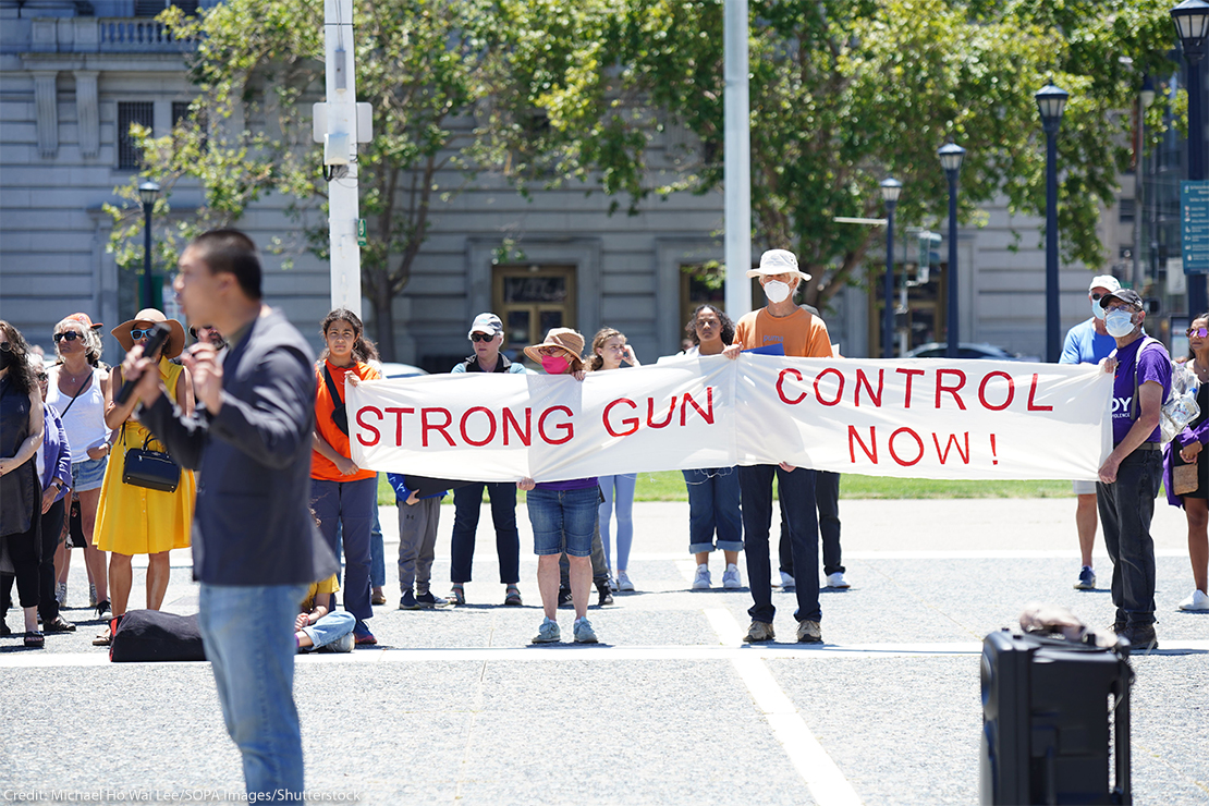 Protesters hold a banner that says "Strong gun control now" during an anti-gun violence rally in San Francisco rally.