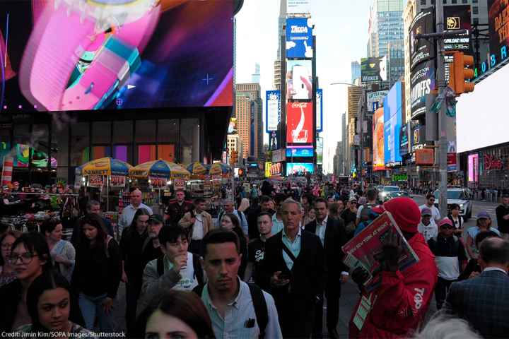 Pedestrians walking through Times Square.