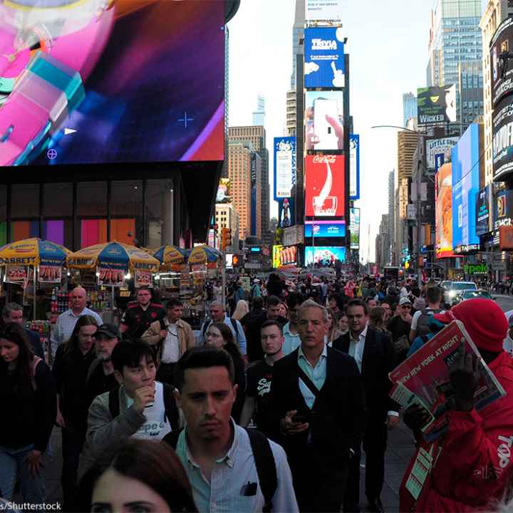 Pedestrians walking through Times Square.