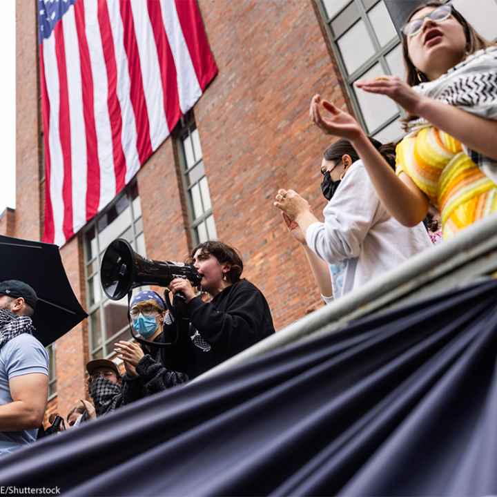 Pro-Palestinian protesters sing in the ongoing student encampment of pro-Palestinian supporters in the University Yard at George Washington University in Washington, DC.