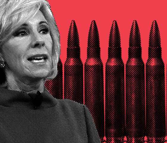 Betsy Devos with pencils and bullets behind her