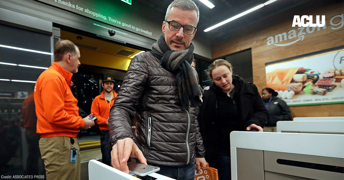 A customer scanning the Amazon Go cellphone app at the entrance of an Amazon Go store