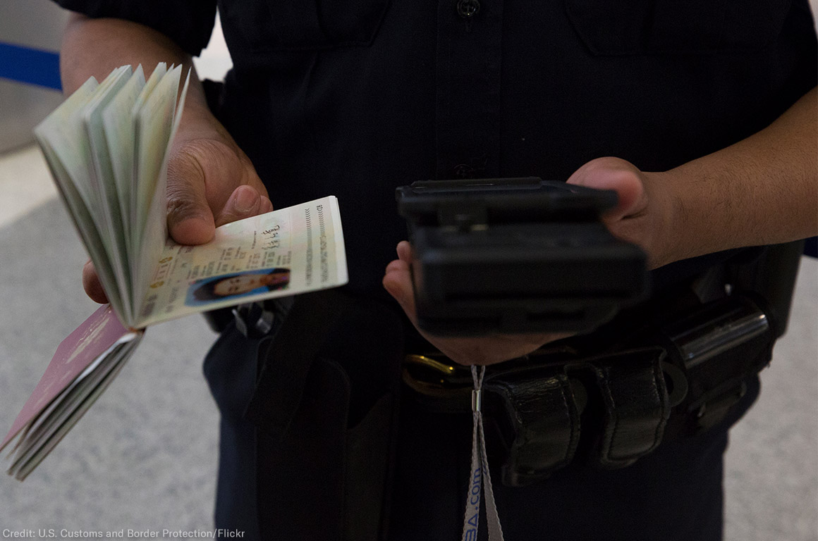 A CBP officer checks a passenger&#039;s ID