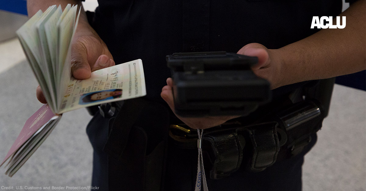 A CBP officer checks a passenger&#039;s ID