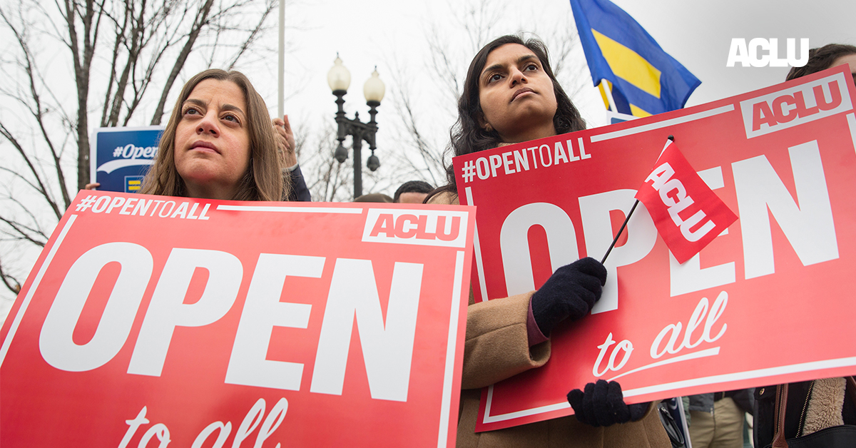 Demonstrators holding signs with the message &quot;Open to All&quot;