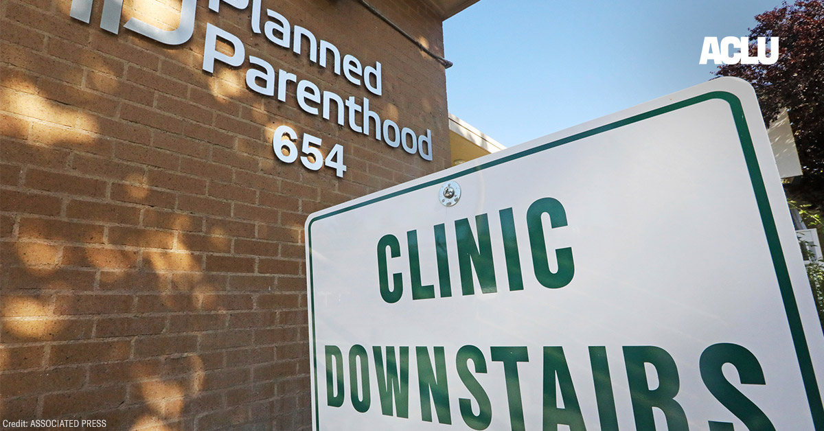 A sign with the text &quot;Clinic Downstairs&quot; outside a Planned Parenthood building